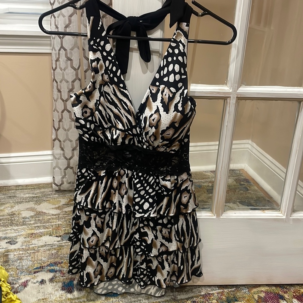 Black, brown and white halter top with layers to the hip line.